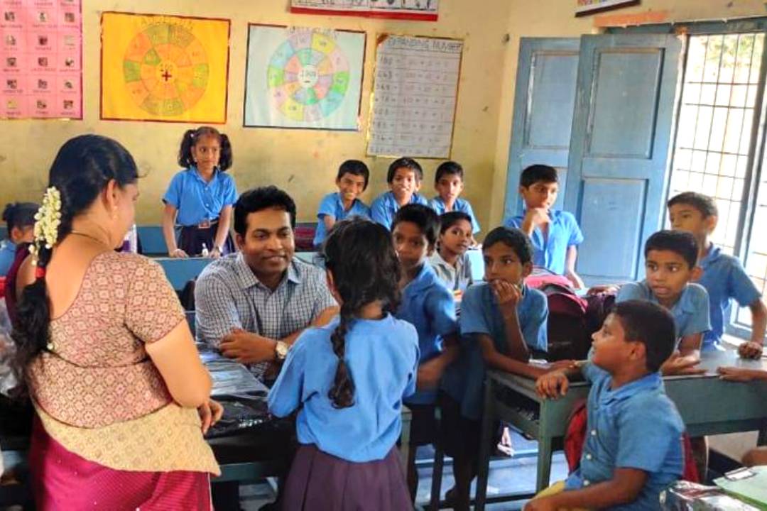 Nigama Foundation team engaging with students in a government school classroom
