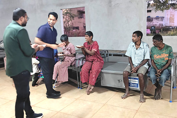 Nigama Foundation team serving a meal to residents at an elder care home