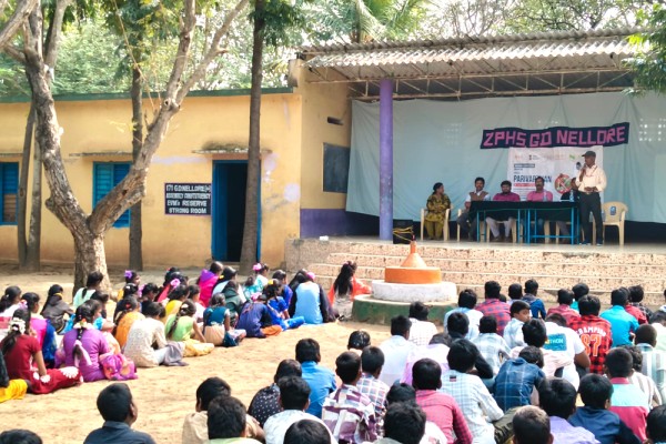 School children gathered at a government high school for a Nigama Foundation program
