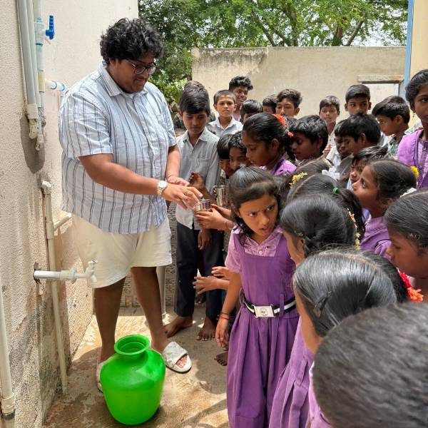 Children at clean water filtration plant installed by Nigama Foundation, Anantapur