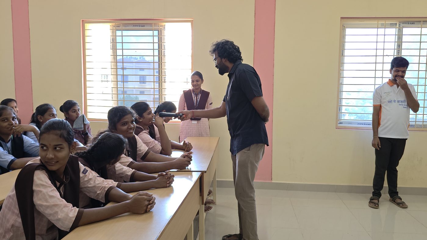 Project Parivarthan — facilitator handing mic to a girl student asking a question in class, Andhra Pradesh